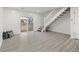 Bright living room with gray floors, sliding glass doors to the yard and staircase to upper level at 1545 S Ouray Cir # A, Aurora, CO 80017