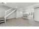 Bright living space with staircase, breakfast bar, and modern wood grain floors at 1545 S Ouray Cir # A, Aurora, CO 80017