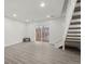 Bright living area with modern flooring, staircase, and sliding glass door to the outside at 1545 S Ouray Cir # A, Aurora, CO 80017