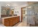 Bright bathroom with double vanity, glass shower, and walk-in closet at 1621 Baneberry Ln, Golden, CO 80401