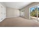 Sun-filled bedroom with plush carpeting, natural light, and sliding patio door at 1621 Baneberry Ln, Golden, CO 80401