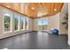 Spacious bonus room with a wood ceiling, multiple windows, and a walkout patio at 1621 Baneberry Ln, Golden, CO 80401