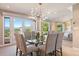 Elegant dining room with modern light fixture and access to balcony with scenic views at 1621 Baneberry Ln, Golden, CO 80401