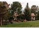 Beautifully landscaped yard surrounds a well-maintained home with a red tile roof at 1621 Baneberry Ln, Golden, CO 80401