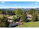 Stunning exterior shot showcasing the home, large trees, and mountain backdrop at 1621 Baneberry Ln, Golden, CO 80401