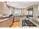 Bright kitchen featuring stainless steel appliances, an island cooktop, and mountain views at 1621 Baneberry Ln, Golden, CO 80401
