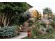 Landscaped yard featuring colorful rocks, steps, and verdant shrubbery at 1621 Baneberry Ln, Golden, CO 80401