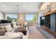 Living room featuring a modern fireplace, large windows, and neutral decor, creating an inviting space at 1621 Baneberry Ln, Golden, CO 80401