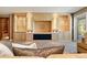 Living room featuring a custom built-in entertainment center and ample lighting at 1621 Baneberry Ln, Golden, CO 80401