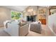 Cozy living room with fireplace, plush seating, and large windows offering scenic outdoor views at 1621 Baneberry Ln, Golden, CO 80401