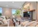 Well-lit living room featuring views of the forest, a fireplace and comfortable seating at 1621 Baneberry Ln, Golden, CO 80401