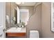 Stylish powder room featuring a vessel sink, decorative mirror, and modern fixtures at 1621 Baneberry Ln, Golden, CO 80401