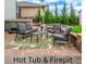 Outdoor patio featuring cushioned seating around a table, along with a hot tub and fire pit at 12330 Village E Cir, Commerce City, CO 80603