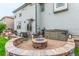 Relaxing backyard with a stone fire pit, hot tub, outdoor seating, and lush green lawn at 12330 Village E Cir, Commerce City, CO 80603