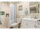 Cozy bathroom featuring a shower with tiled walls and a single sink vanity at 12330 Village E Cir, Commerce City, CO 80603