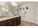 Bright bathroom features a double vanity, granite counters, tile floor, and modern fixtures at 12330 Village E Cir, Commerce City, CO 80603