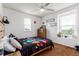 Bright bedroom with a ceiling fan, large windows, and modern décor, ideal for a restful space at 12330 Village E Cir, Commerce City, CO 80603