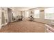 Large bonus room offering flexible space with natural light from many windows at 12330 Village E Cir, Commerce City, CO 80603