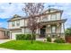 Inviting home exterior features a lush front lawn and covered porch for relaxing at 12330 Village E Cir, Commerce City, CO 80603