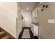 Welcoming foyer with hardwood floors, a console table, and an elegant staircase at 12330 Village E Cir, Commerce City, CO 80603