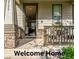 Inviting front porch features stone accents and a cozy seating area for relaxing outdoors at 12330 Village E Cir, Commerce City, CO 80603