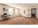 Spacious living room features bright windows, neutral tones, and flexible design with desk and rocking chairs at 12330 Village E Cir, Commerce City, CO 80603