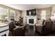 Cozy living room with a fireplace, plush seating, and an entertainment center for relaxation at 12330 Village E Cir, Commerce City, CO 80603