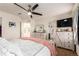 Bright bedroom featuring a ceiling fan, stylish dressers, an ensuite bathroom, and ample closet space at 12330 Village E Cir, Commerce City, CO 80603