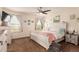 Charming main bedroom features bright windows, ceiling fan, and coastal decor with ample closet space at 12330 Village E Cir, Commerce City, CO 80603