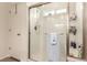 Clean and bright shower with glass door and tile surround, complete with modern fixtures and storage at 12330 Village E Cir, Commerce City, CO 80603