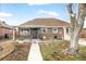 Well-kept brick home with a tidy front yard and covered entrance at 875 S Dale Ct, Denver, CO 80219