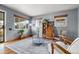 Cozy living room with a large area rug, wood floors, and vintage wooden furniture at 875 S Dale Ct, Denver, CO 80219