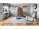Open living room with an area rug, lots of vintage furniture, and natural light at 875 S Dale Ct, Denver, CO 80219