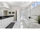 Elegant bathroom featuring marble flooring, soaking tub, walk-in shower and double vanity at 301 Garfield St # 1E, Denver, CO 80206