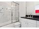 Modern bathroom with white marble, sleek fixtures, and a glass-enclosed shower tub at 301 Garfield St # 1E, Denver, CO 80206