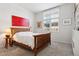Cozy bedroom with natural light, featuring hardwood floors, neutral walls, and an art piece on the wall at 301 Garfield St # 1E, Denver, CO 80206