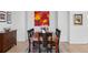 Bright dining room featuring a wooden table with seating and a vibrant art piece on the wall at 301 Garfield St # 1E, Denver, CO 80206