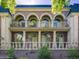 Elegant multi-story home featuring arched windows and a brick facade, complemented by lush greenery at 301 Garfield St # 1E, Denver, CO 80206