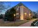 Brick multi-story building with traditional architectural details, lush landscaping, and a pathway at 301 Garfield St # 1E, Denver, CO 80206