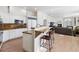 Modern kitchen with granite counters, stainless appliances, and a breakfast bar flowing into the living area at 301 Garfield St # 1E, Denver, CO 80206