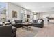 Spacious living room with large windows, plush seating, and a seamless transition to the kitchen at 301 Garfield St # 1E, Denver, CO 80206