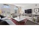 Spacious living room with large windows, built-in shelving, and comfortable seating arrangement at 301 Garfield St # 1E, Denver, CO 80206