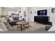 Inviting living room featuring a gray sofa, modern entertainment center, and open layout to the kitchen at 301 Garfield St # 1E, Denver, CO 80206