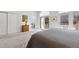Spacious bedroom featuring an ensuite bathroom, patio doors, and elegant neutral decor at 301 Garfield St # 1E, Denver, CO 80206