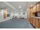 Open basement area with carpet flooring, storage cabinets, and versatile space at 5155 W Quincy Ave # 101, Denver, CO 80236