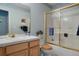 Well-lit bathroom with a shower-tub, vanity with ample counter space, and gold-colored hardware at 5155 W Quincy Ave # 101, Denver, CO 80236