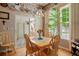 Charming dining room with wood floors, chandelier, and natural light from large windows at 5155 W Quincy Ave # 101, Denver, CO 80236