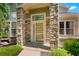 Inviting front entrance with stone columns and a decorative glass door at 5155 W Quincy Ave # 101, Denver, CO 80236