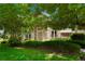 Charming home exterior with stone accents and lush landscaping providing shade at 5155 W Quincy Ave # 101, Denver, CO 80236