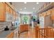 Well-lit kitchen with hardwood floors, wooden cabinets and a breakfast nook near the windows at 5155 W Quincy Ave # 101, Denver, CO 80236